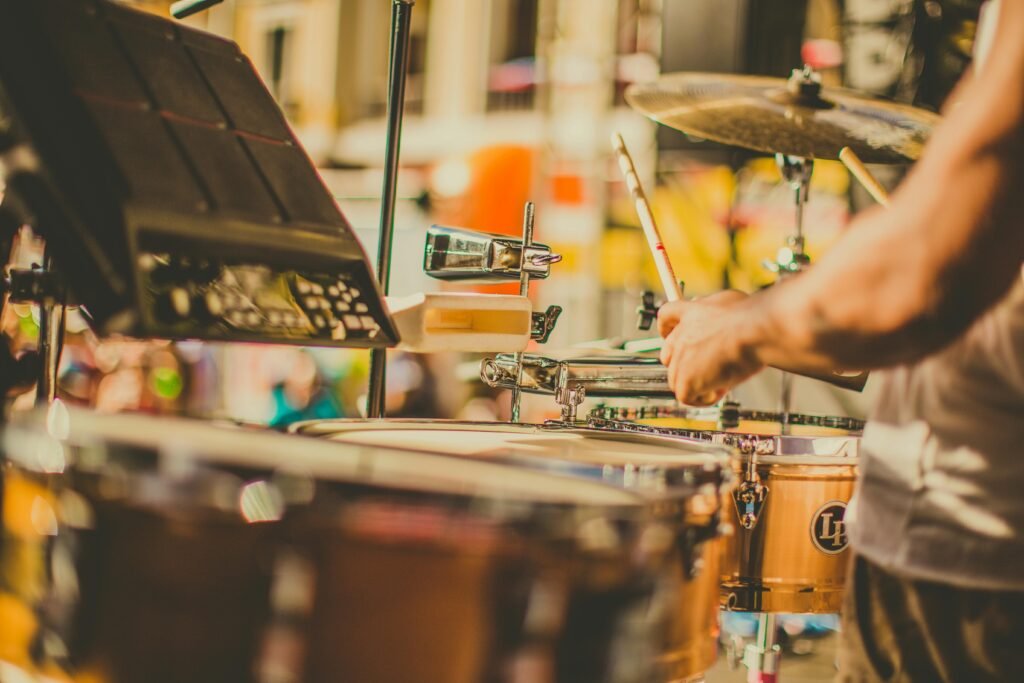 Street drummer in action, showcasing skillful percussion techniques during a vibrant outdoor performance.
