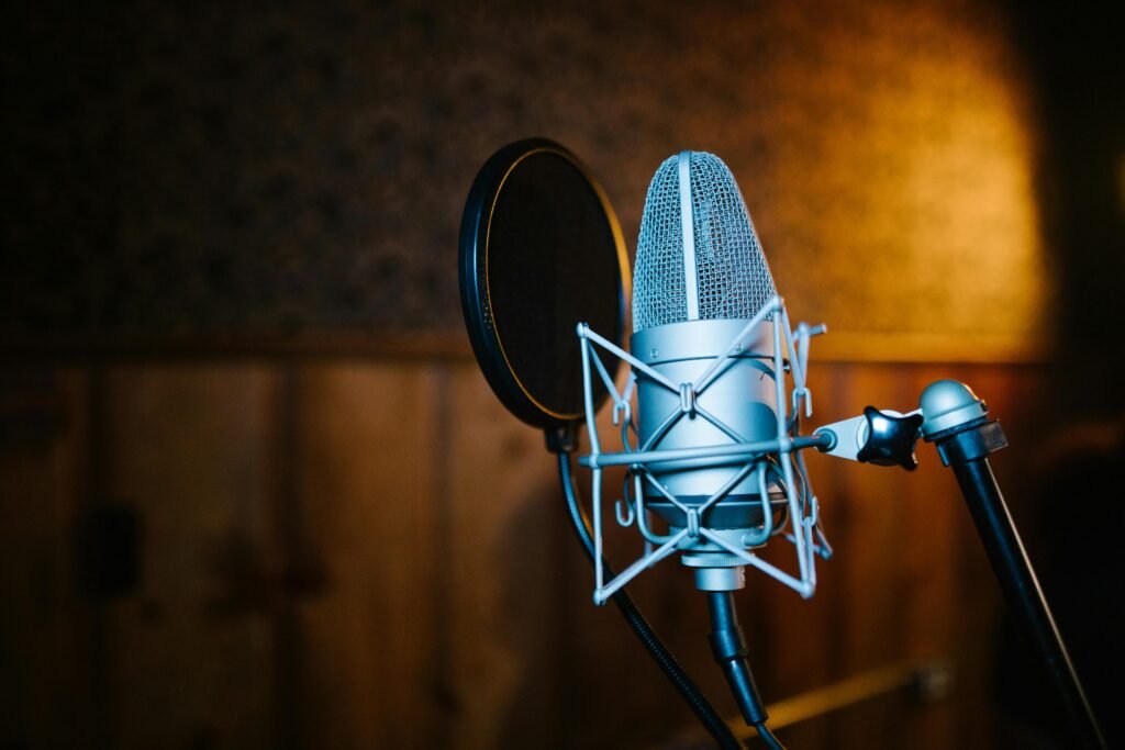 Close-up view of a professional microphone and pop filter setup in a recording studio, perfect for audio and music recording.